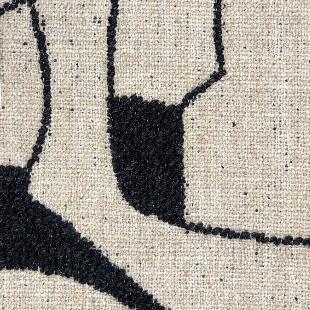 Faded Black fabric with a geometric pattern of off-white shapes, creating a bold and graphic art.