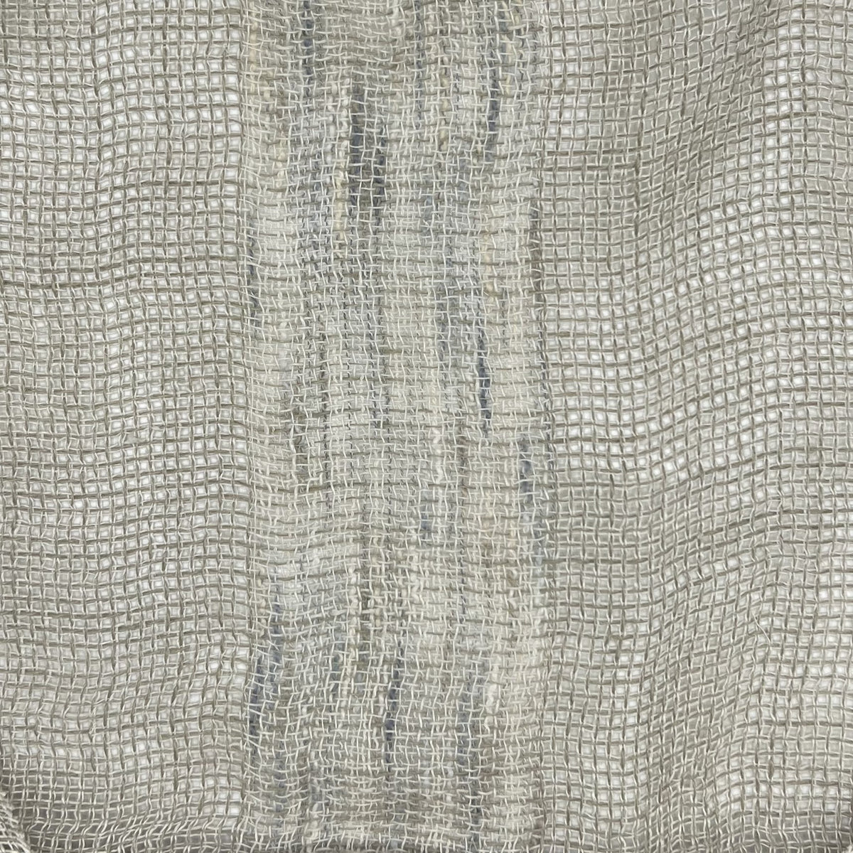 Light gray fabric highlighting the texture of the weave and the variations in thread thickness, contributing to the uneven shading.