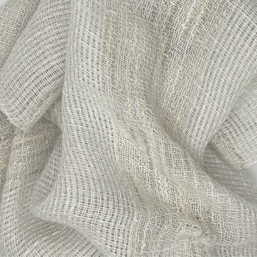 Loose weave off-white fabric with large wavy folds