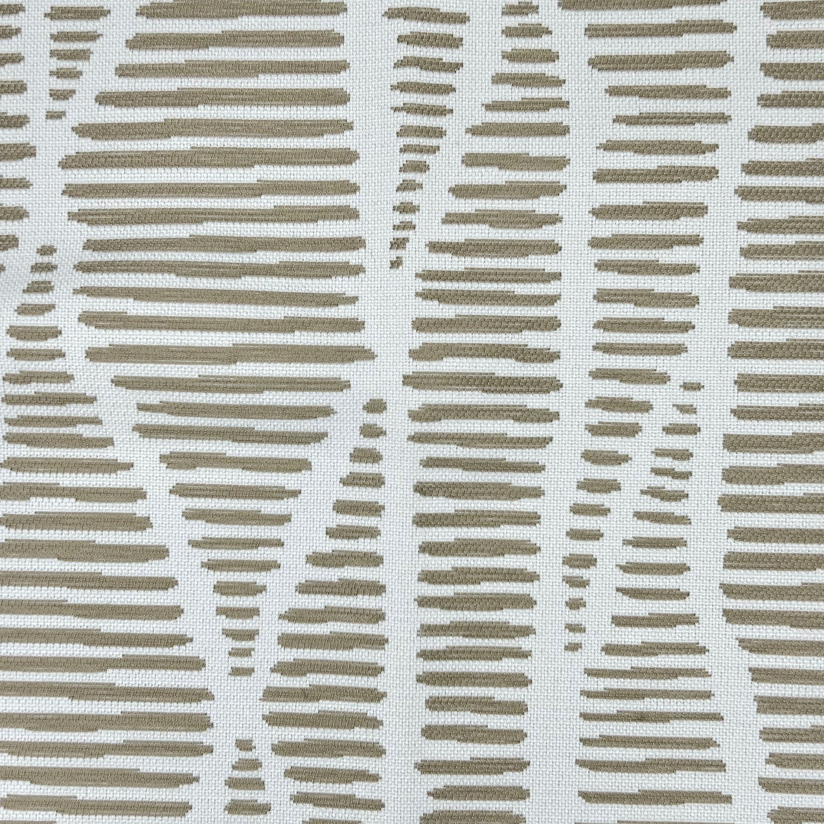 An off-white fabric showing the textured background and the beige, raised, linear pattern, creating a interesting visual effect.