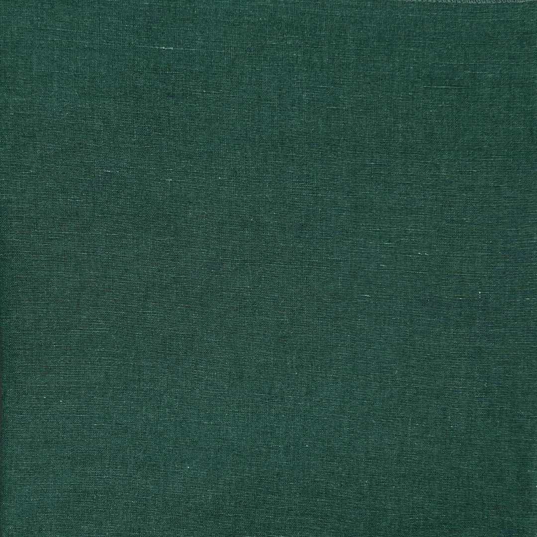 Close-up of dark green fabric highlighting the even texture and color.